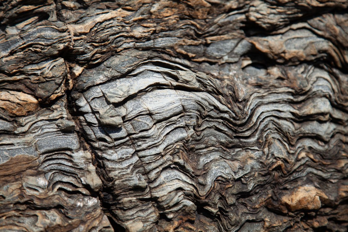 curved rock with fissures